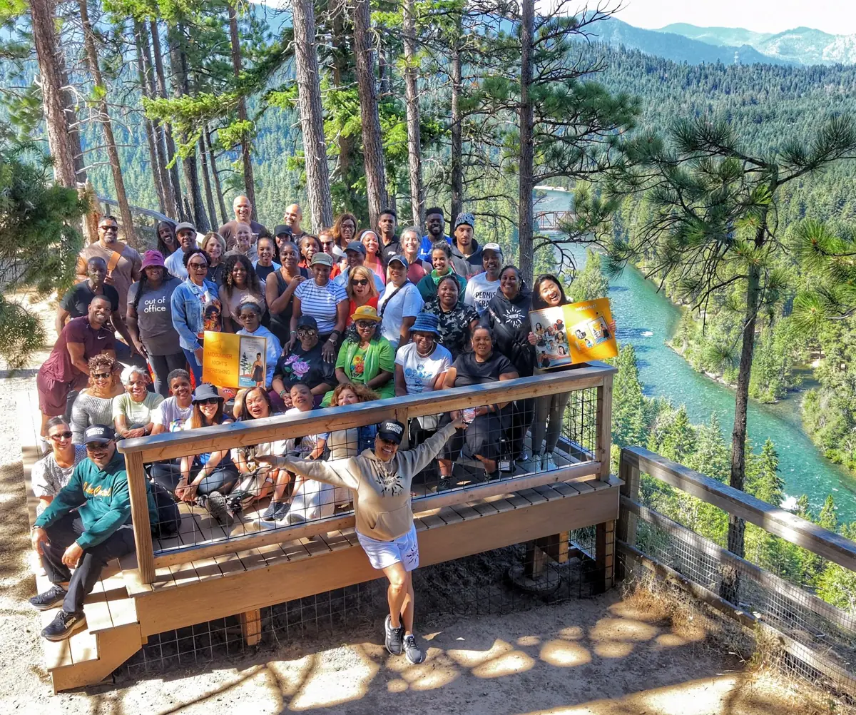 The full Refresh Retreat group at the Cle Elum River overlook, Kim Fields front with arms out